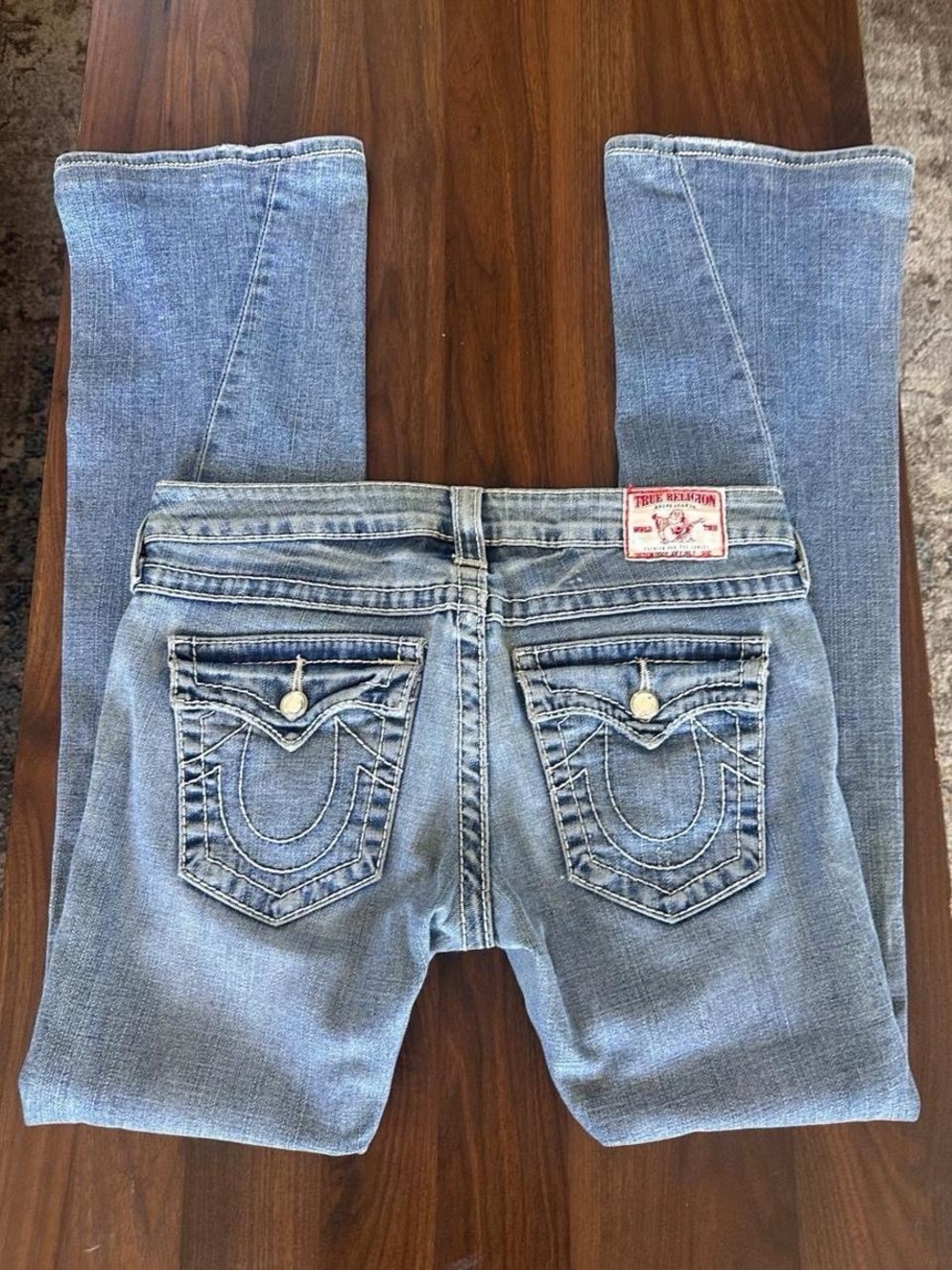 True Religion Light Blue Bootcut Jeans with Signature Back Pockets and Gemstones